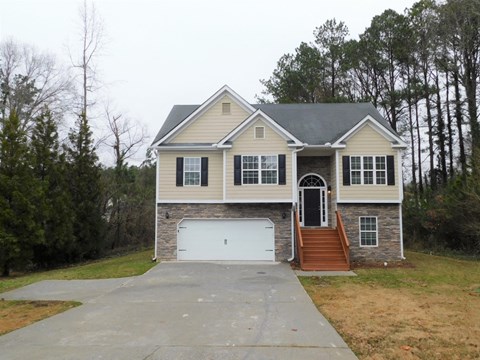 the front of a house with a white garage door